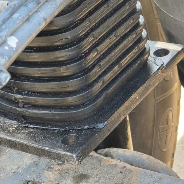 Stacked heavy duty leaf spring pack fitted to a truck chassis
